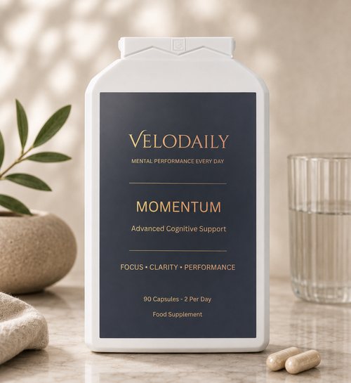 Velodaily Momentum 90-capsule bottle beside two capsules and a glass of water.